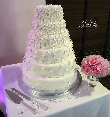 This Hydrangea wedding cake was created for the bride as it is her favorite flower.  All the petals are handmade and dusted and are entirely edible.  The 6-tiers are a combination of Chocolate, Fruit and Lemon cakes.   